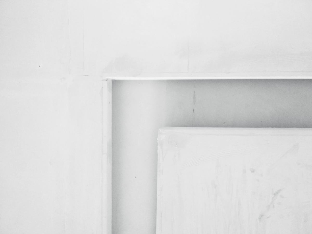 Close view of a white painted raised-panel door.