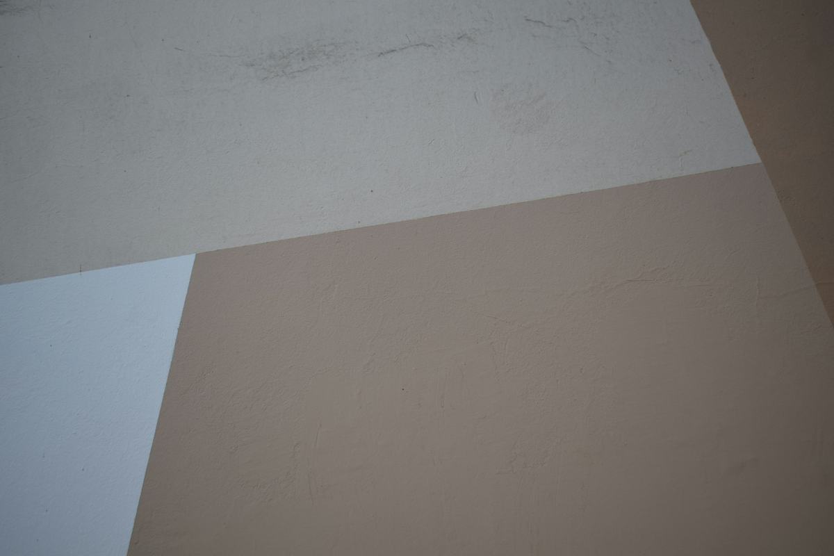 Smooth finished wall and ceiling planes meeting at clean corners.